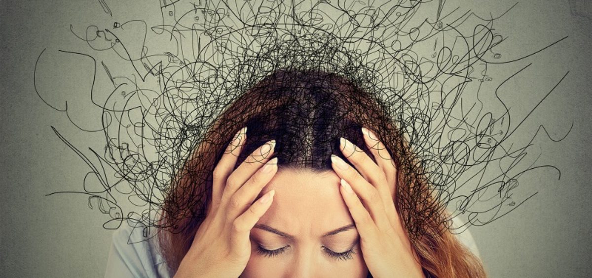 Stressed woman holding head in her hands