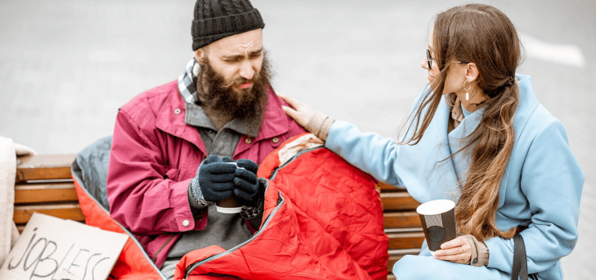 Woman comforting a homeless man