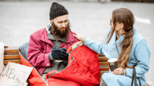 Woman comforting a homeless man