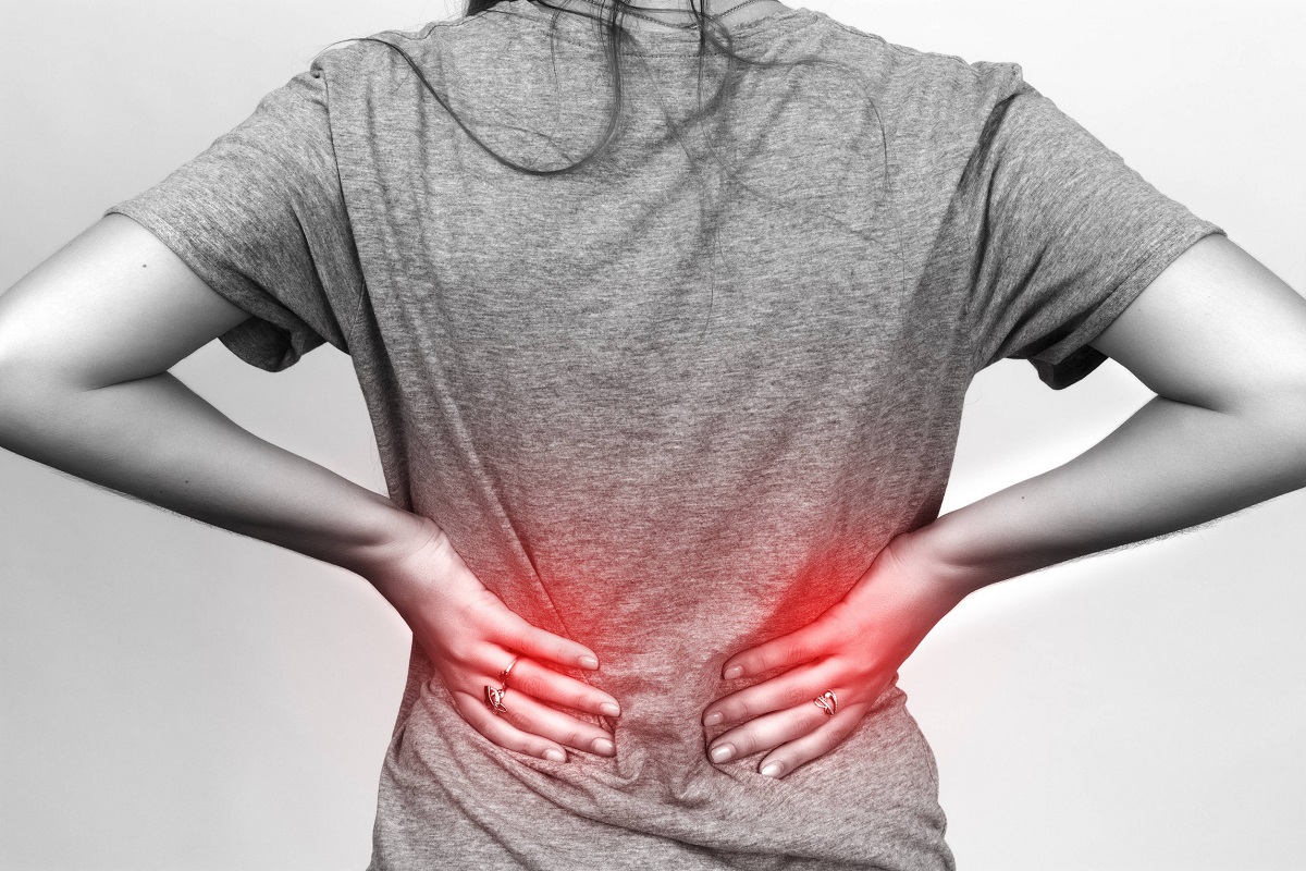 Illustration of a woman suffering from lower back pain due to degenerative spinal disease