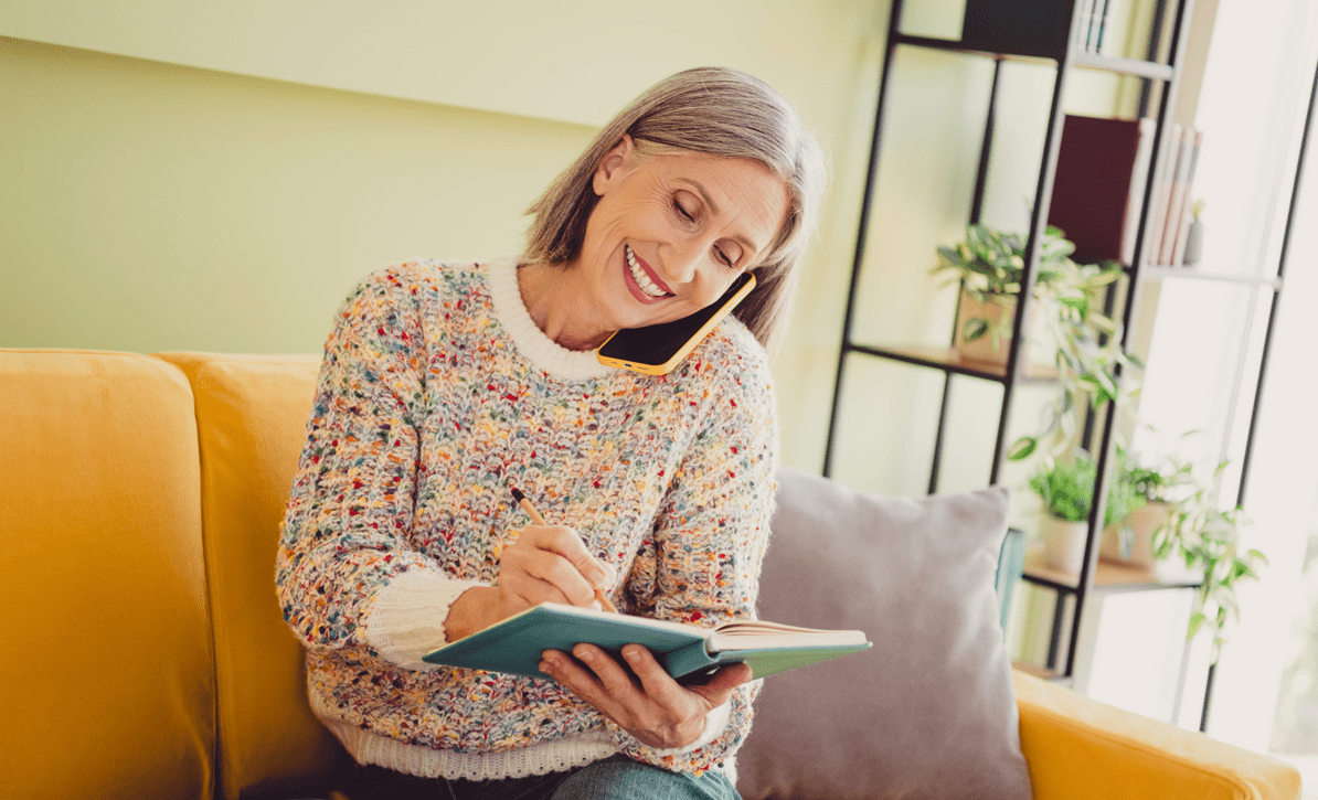 Image of an elderly woman on the phone in her home.